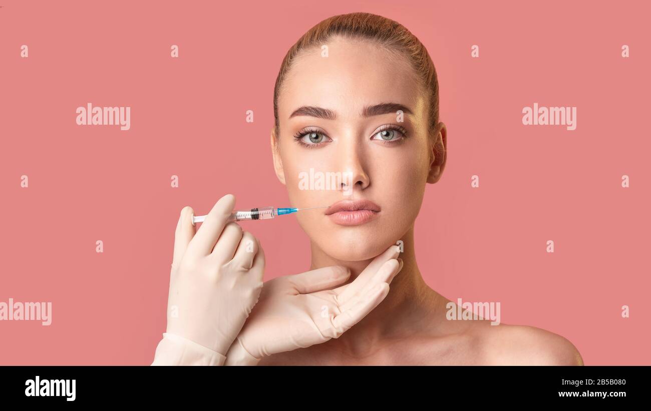 Model Girl Receiving Injection During Lips Plumping Procedure, Pink