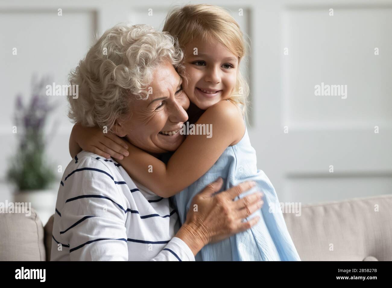 Cute little girl have fun with mature grandmother at home Stock Photo ...