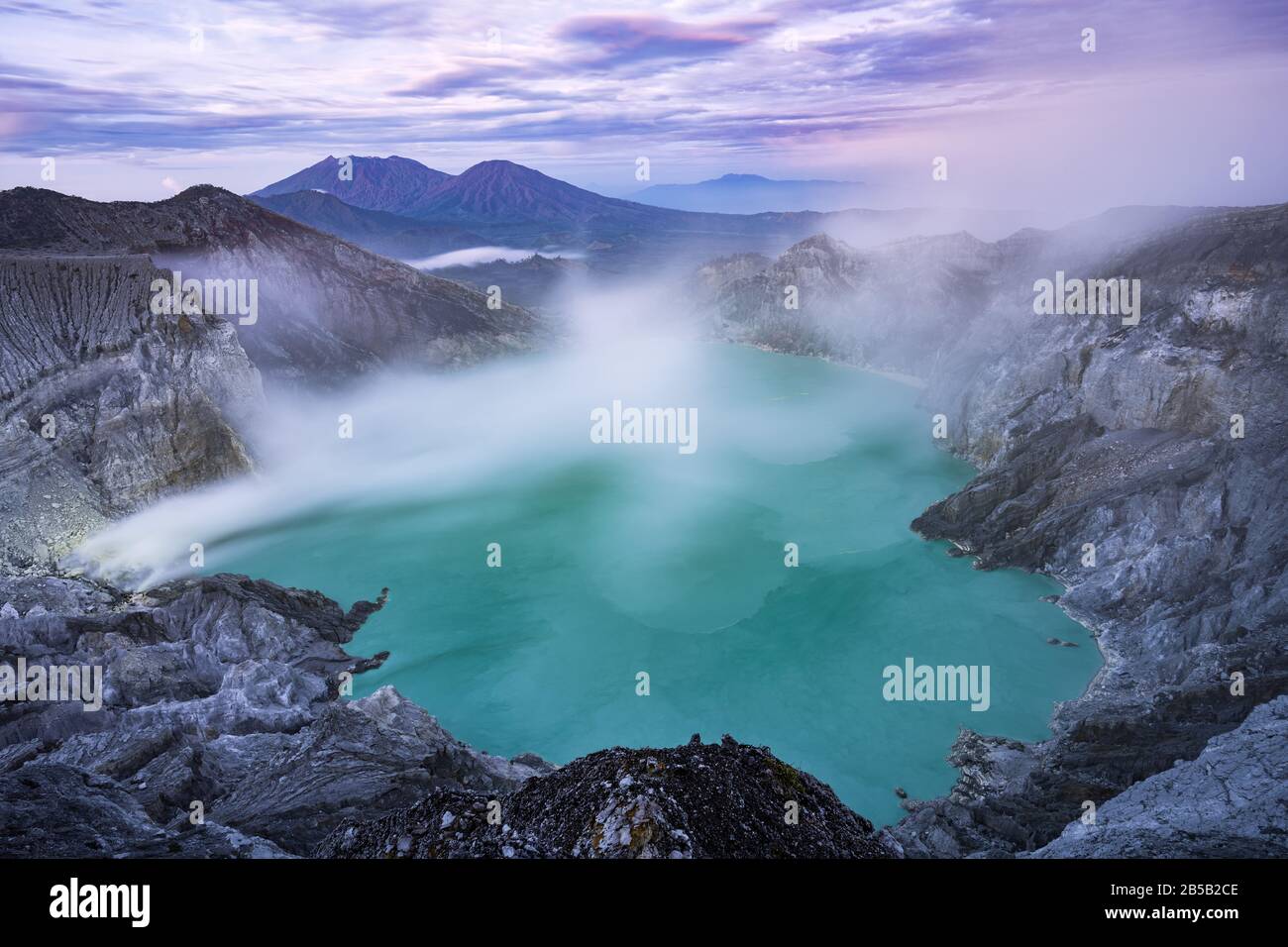 View from above, stunning view of the Ijen volcano with the turquoise-coloured acidic crater lake. Stock Photo