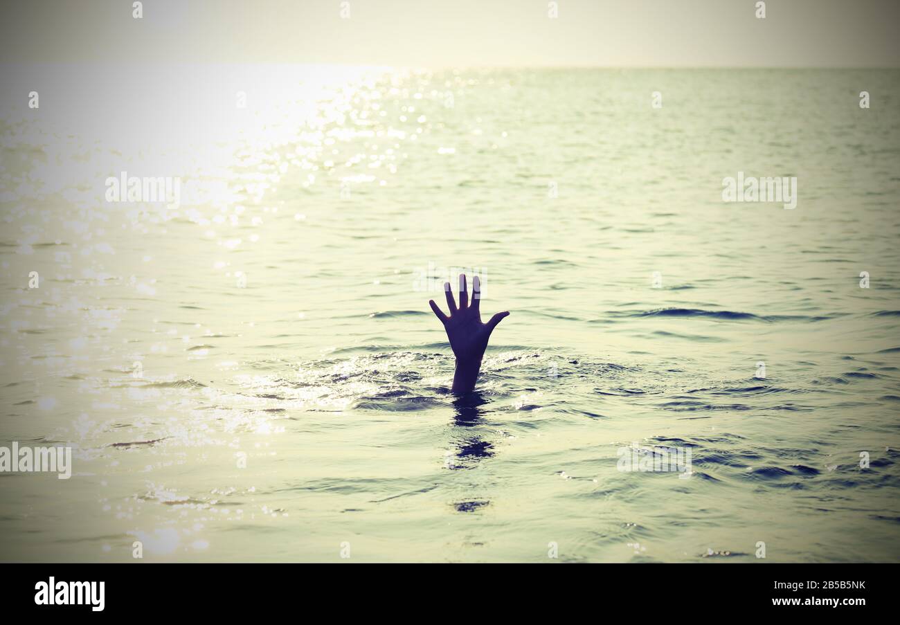 hand of a drowning man raised for help Stock Photo