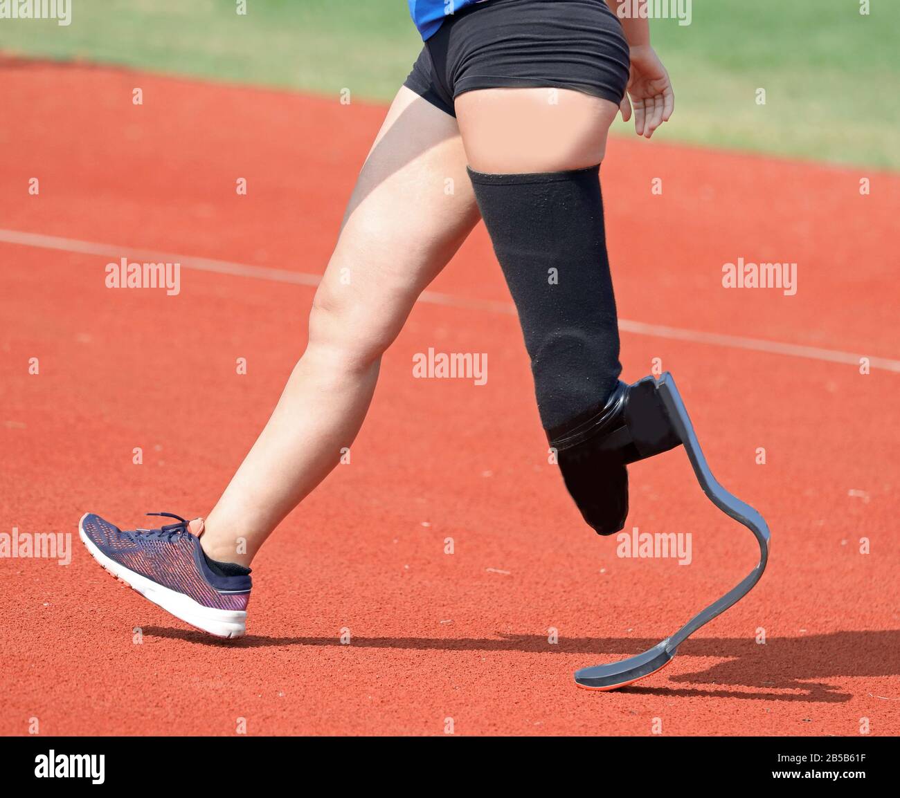Paralympic athlete with prosthesis in the left leg in the running track