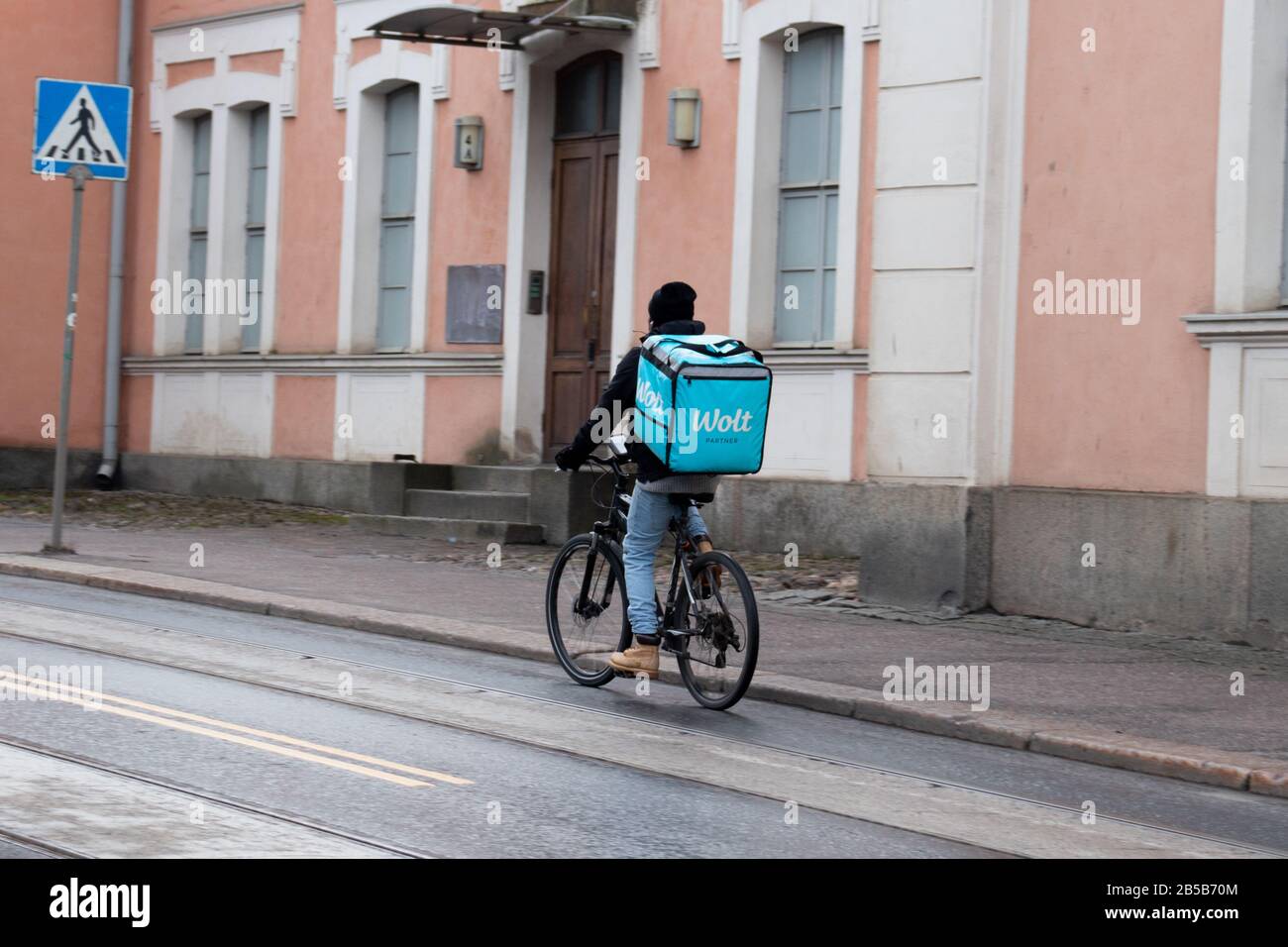 Helsinki, Finland - 3 March 2020: Wolt Partner bike delivery man on street, Illustrative Editorial Stock Photo