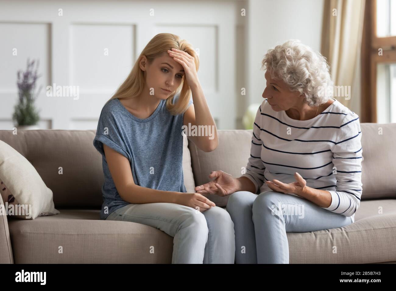 Authoritative mature mom lecturing frustrated grownup daughter Stock Photo