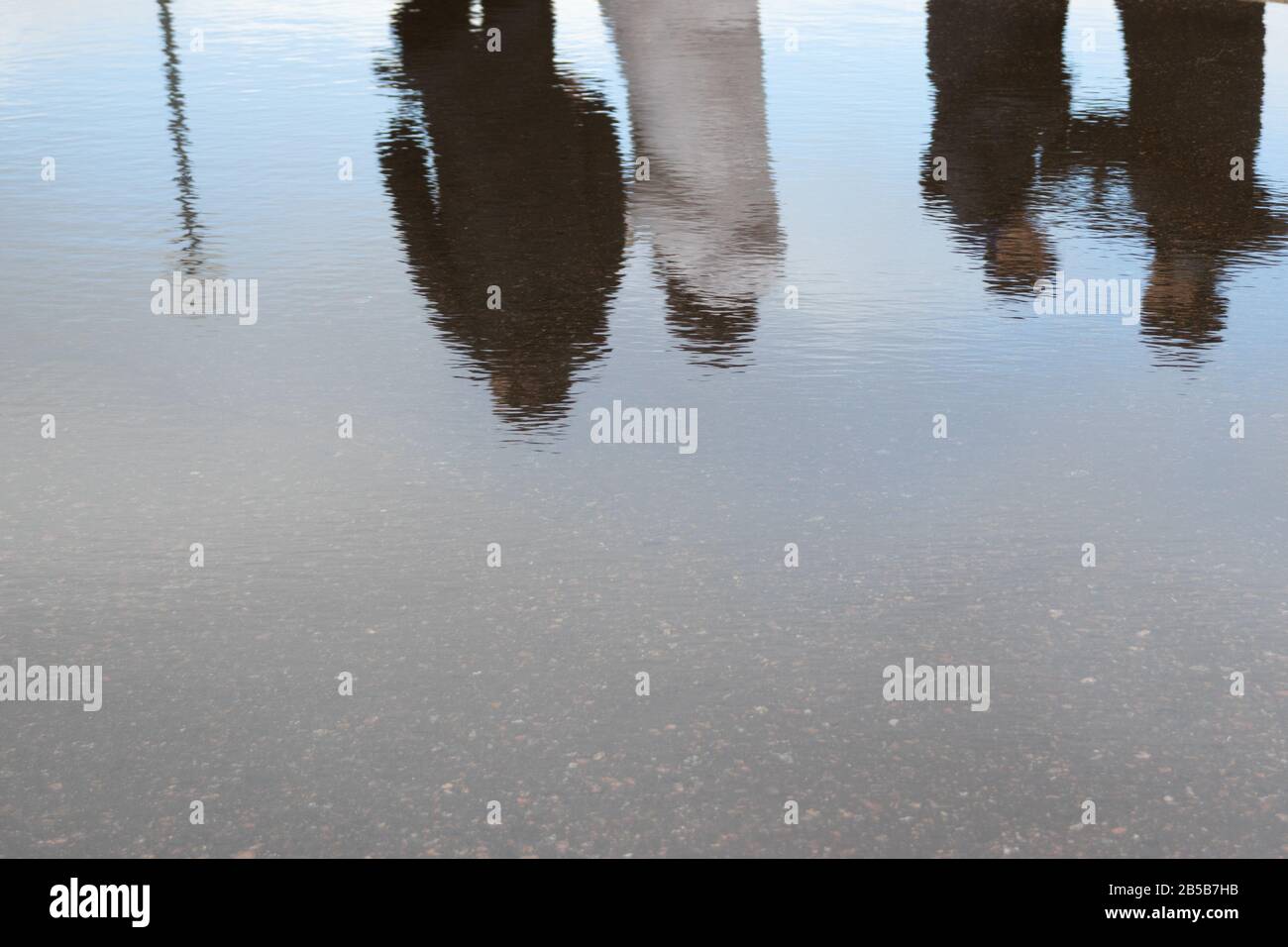 Reflection of a group of people in the water. Copy space on water background and sky Stock Photo