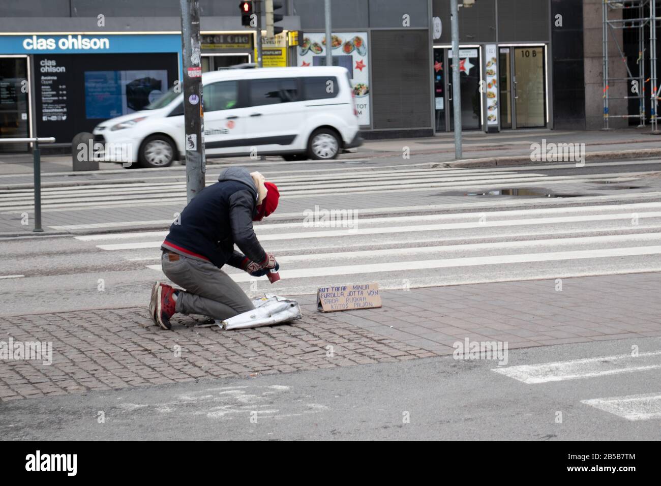 Helsinki, Finland - 3 March 2020: Homeless poor man on Helsinki street , Illustrative Editorial Stock Photo