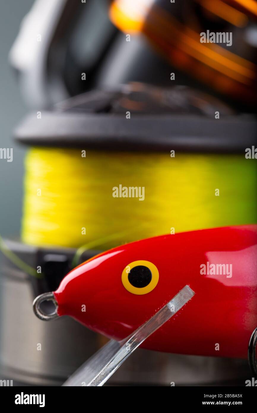 Fishing lures close-up. Wobbler, reel, fishing line in bright color Stock  Photo - Alamy