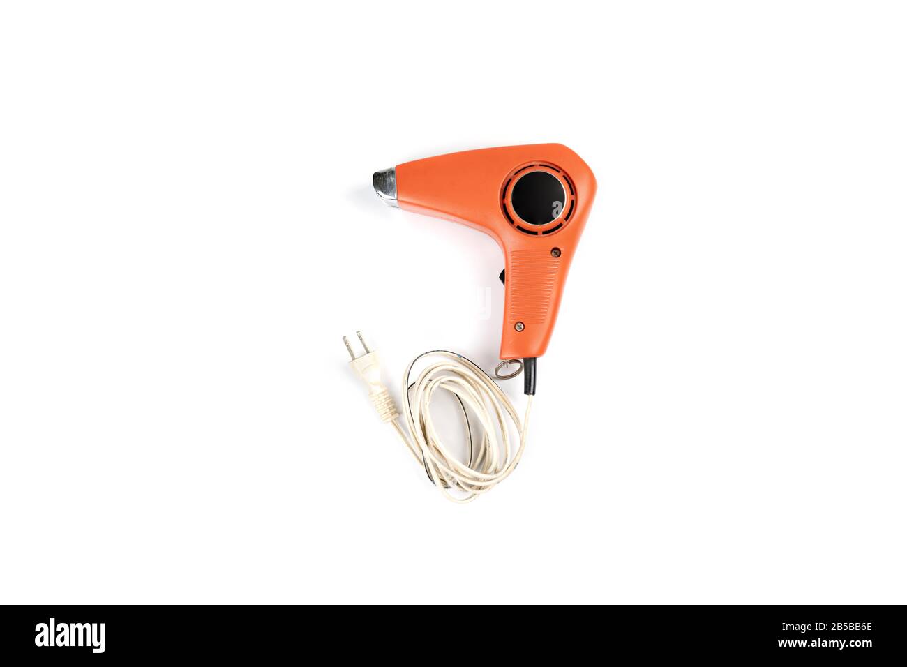 Vintage orange hair dryer on white background with rolled cable buttom. Stock Photo