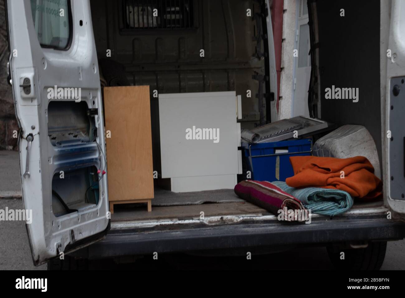 Opened truck door with things. Moving to another apartment concept Stock Photo