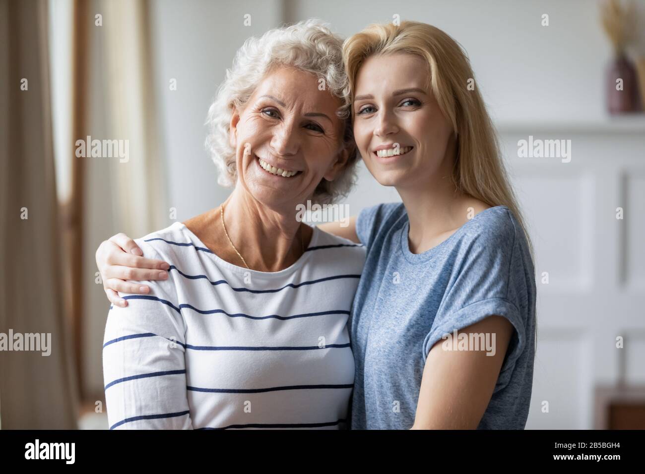 Portrait of happy mature mom and adult daughter hugging Stock Photo