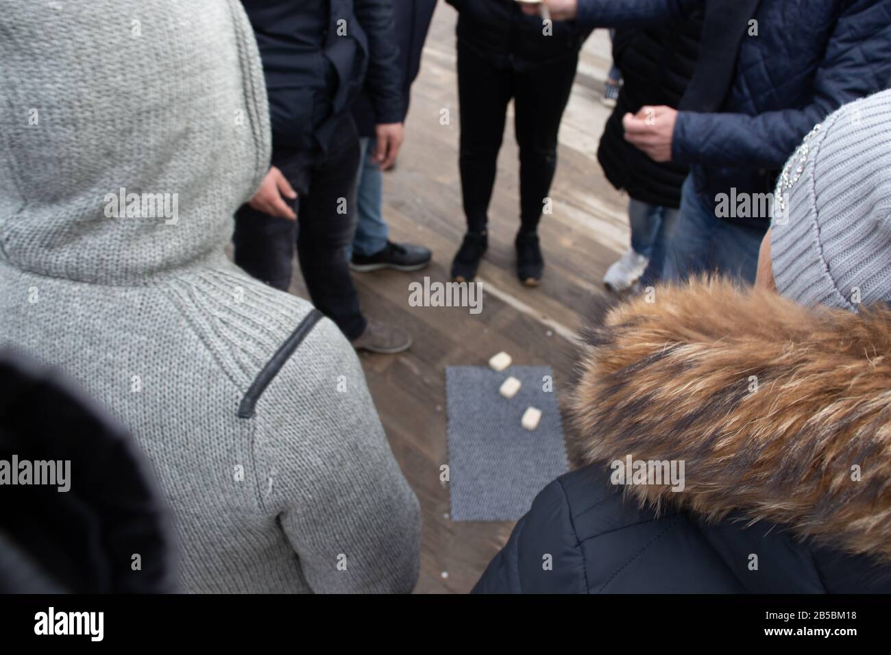 Helsinki, Finland - 3 March 2020: Cheating people on the street. The crowd is standing around and watching the gambling , Illustrative Editorial Stock Photo