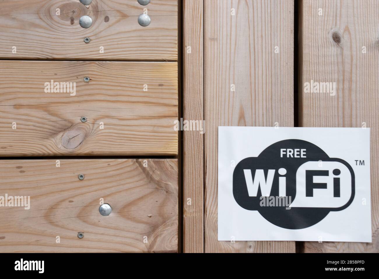 Helsinki, Finland - 3 March 2020: WiFi icon on wooden background , Illustrative Editorial Stock Photo