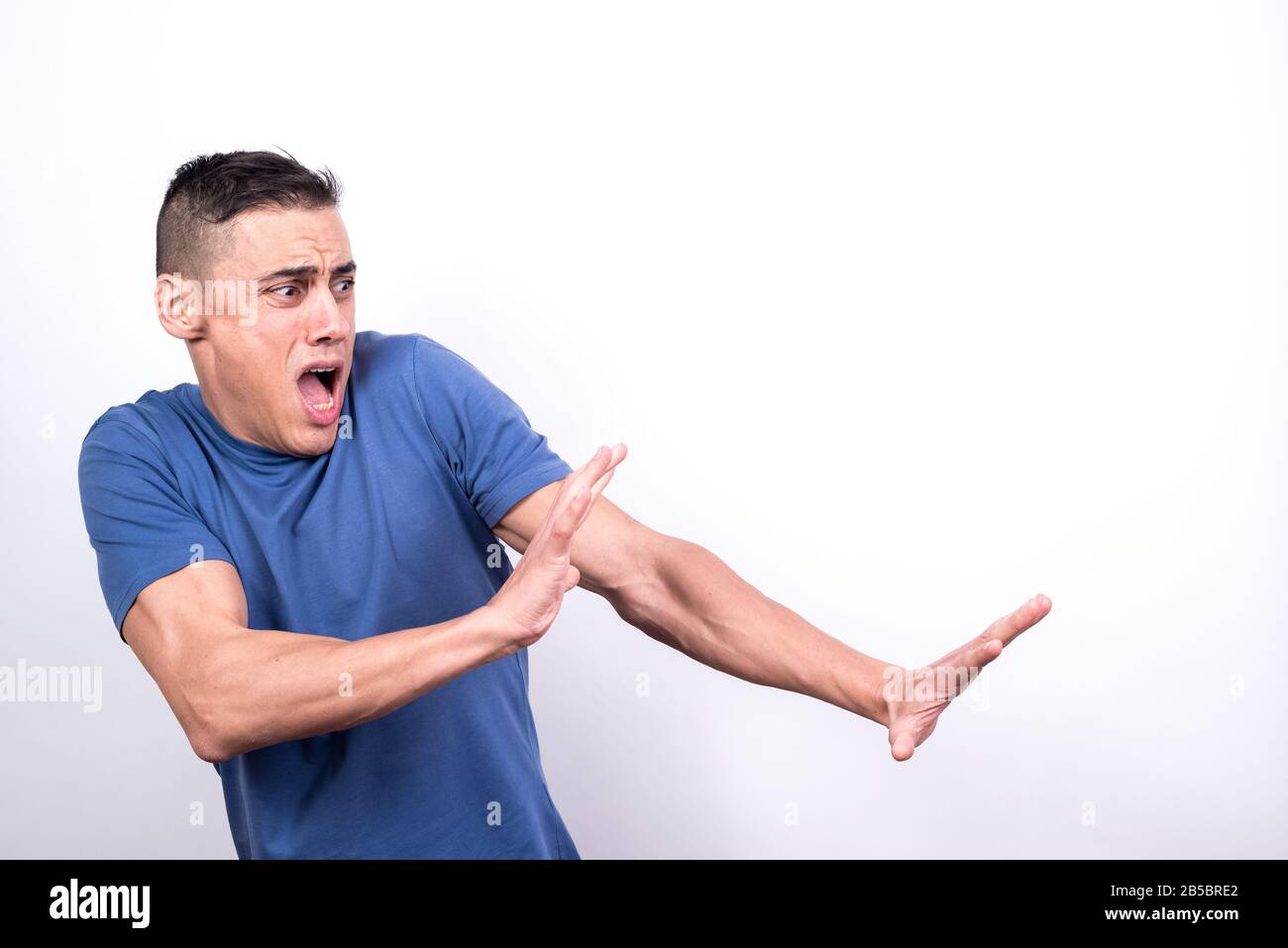 Scared man on white background, medium shot Stock Photo