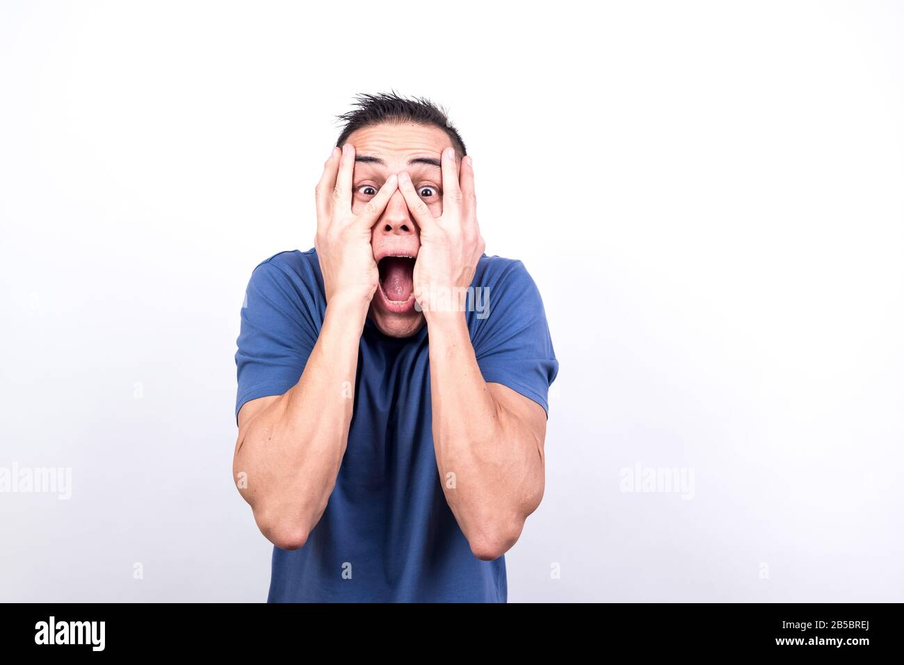 Scared man on white background, medium shot Stock Photo