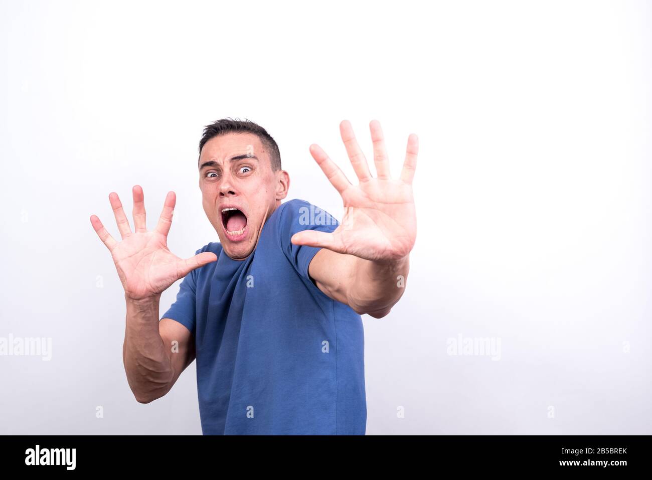 Scared man on white background, medium shot Stock Photo