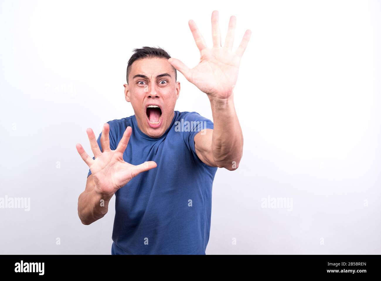 Scared man on white background, medium shot Stock Photo