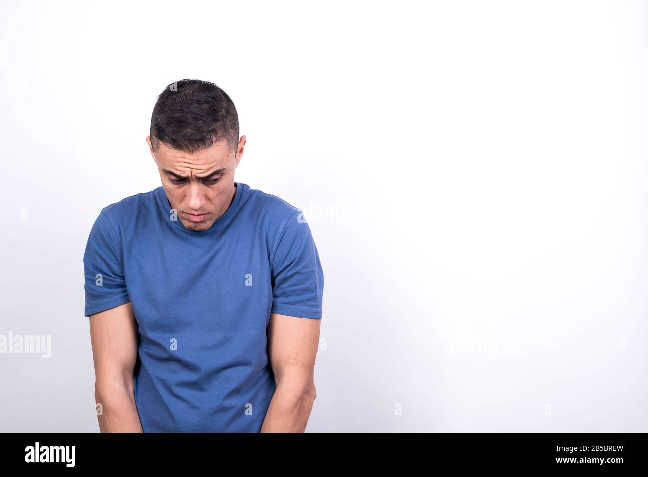 Scared man on white background, medium shot Stock Photo