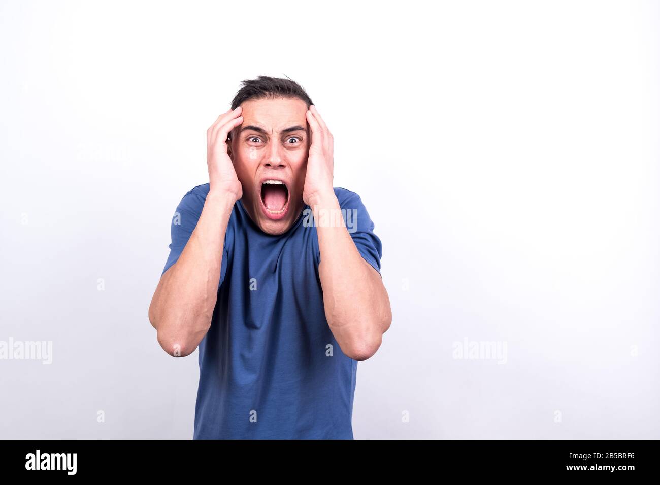 Scared man on white background, medium shot Stock Photo