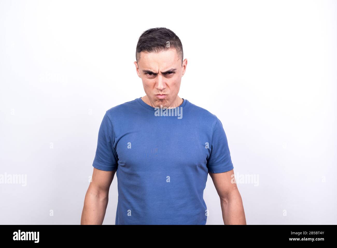 Angry man. white background, medium shot Stock Photo - Alamy