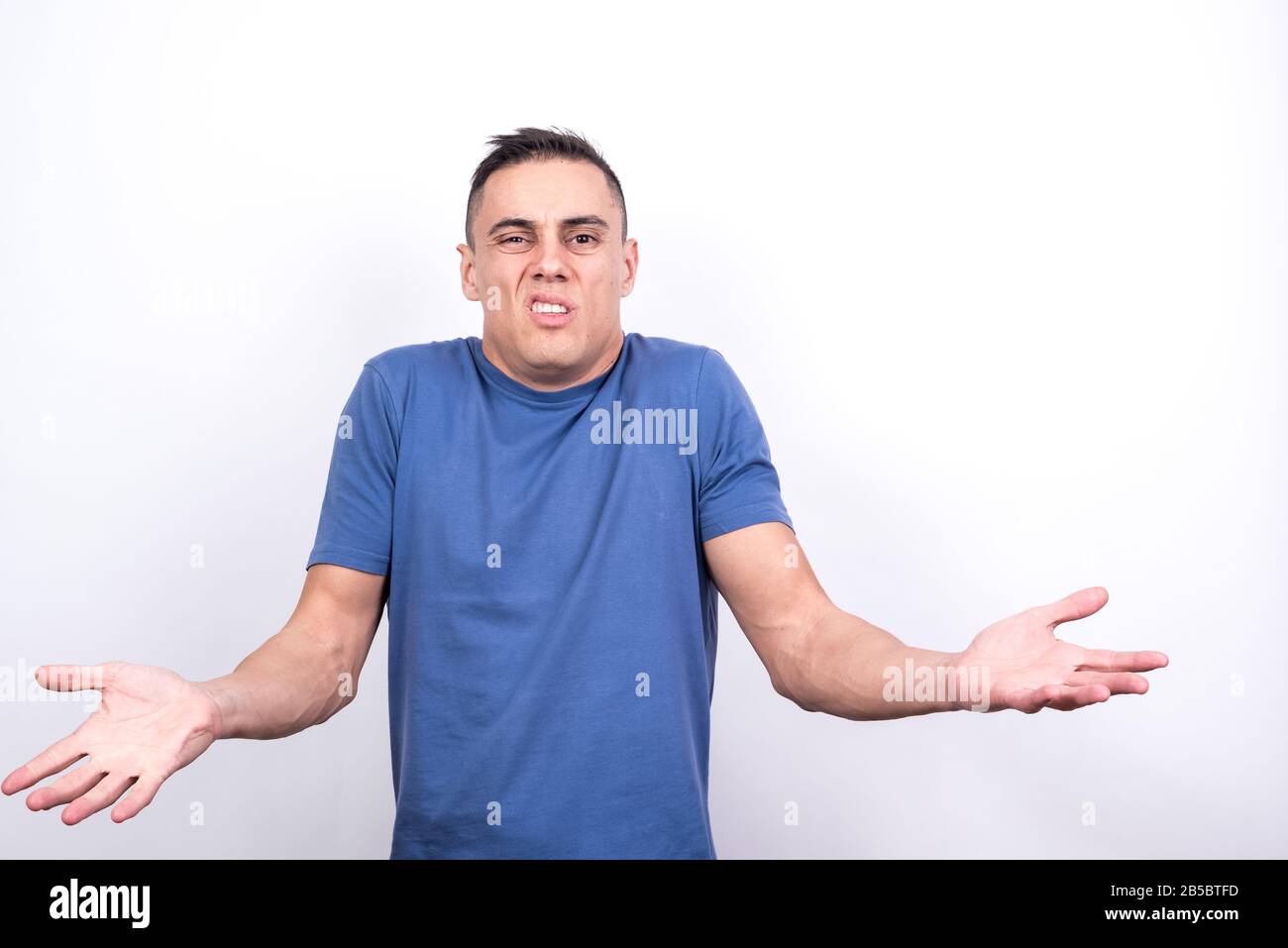 Doubting man. White background, Medium shot Stock Photo