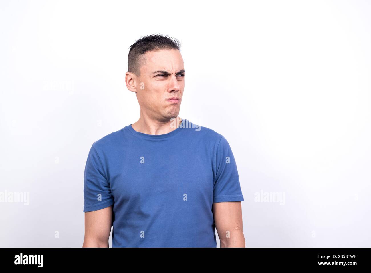 Doubting man. White background, Medium shot Stock Photo