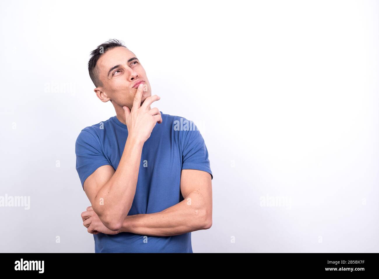 Dreamy man. White background, Medium shot Stock Photo