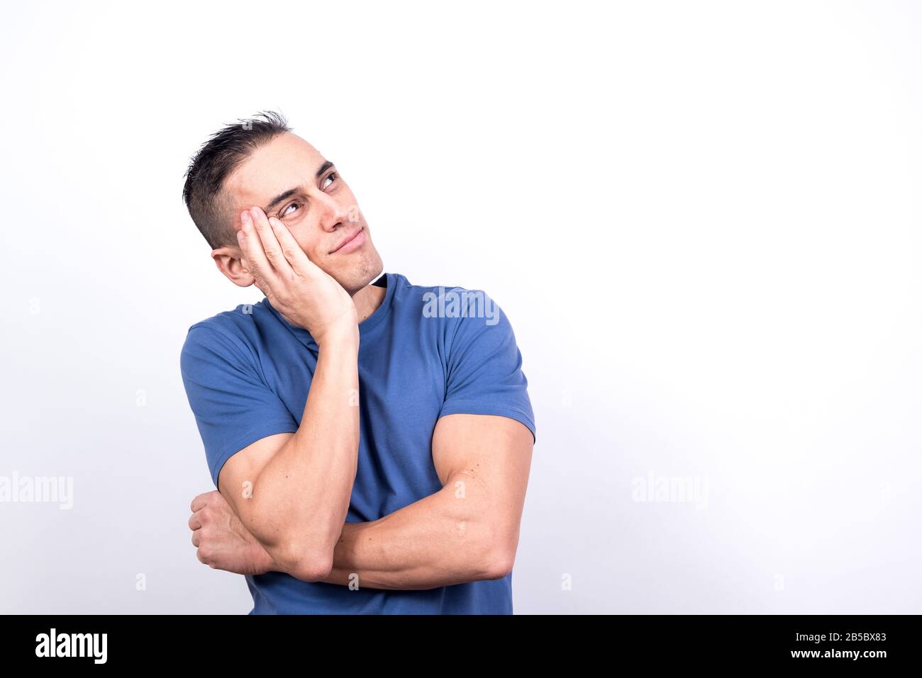 Dreamy man. White background, Medium shot Stock Photo