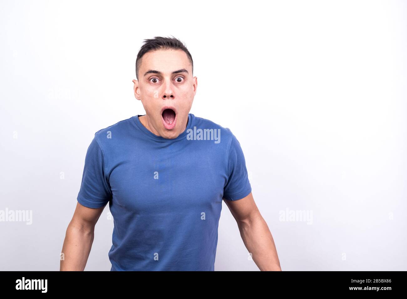 Surprised man. White background, Medium shot Stock Photo