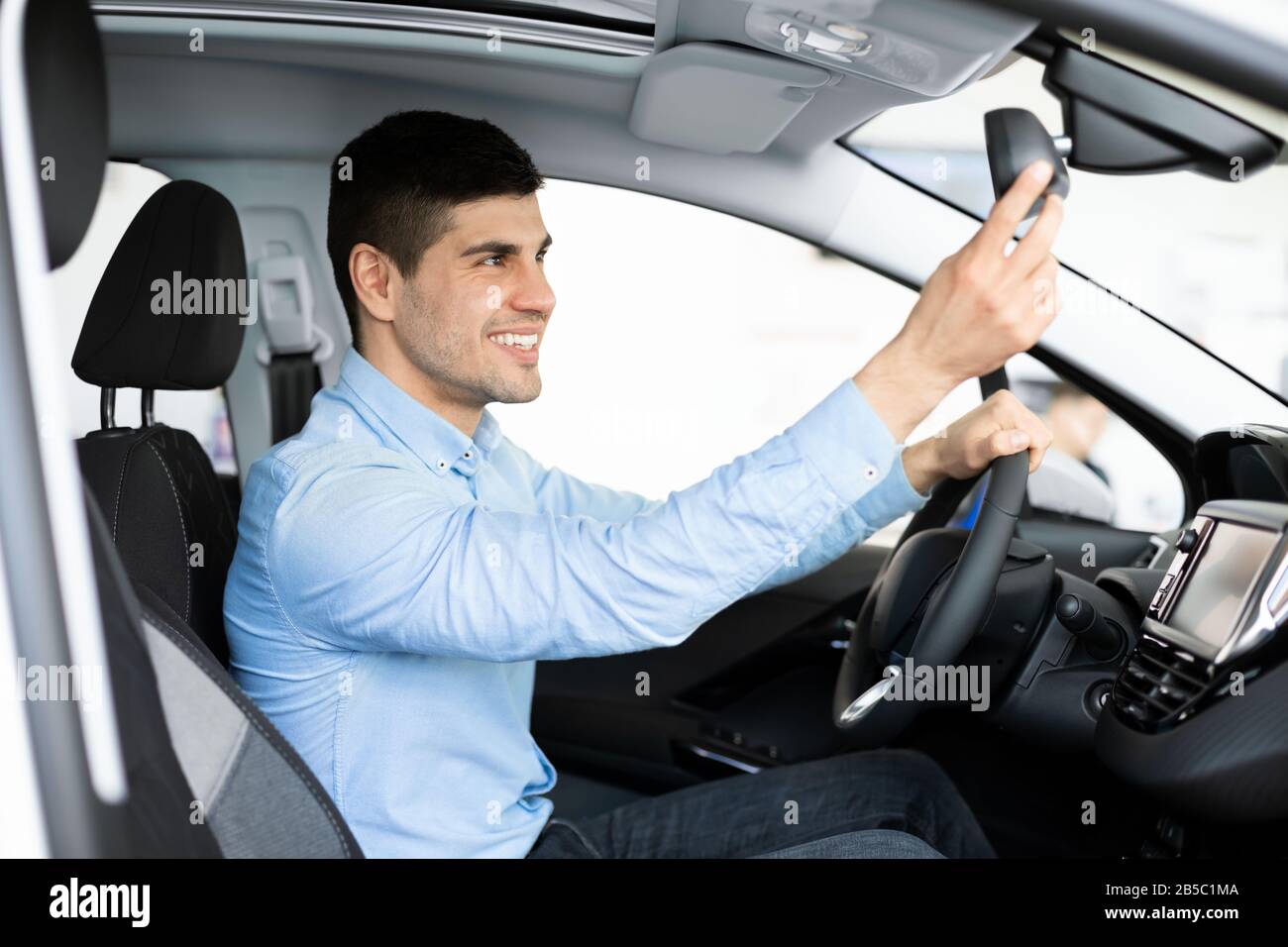 Guy Checking Mirrors Sitting In Driver's Seat Stock Photo Alamy
