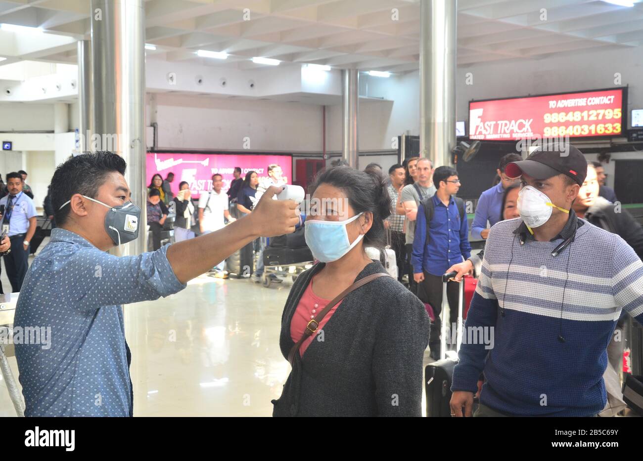 Dimapur, India. 08th Mar, 2020. Dimapur, India March 08, 2020: A Medical official use a thermal screening device on a passenger wearing protective mask on the wake of Corona Virus at Dimapur Airport, India north eastern state of Nagaland. Credit: Caisii Mao/Alamy Live News Stock Photo