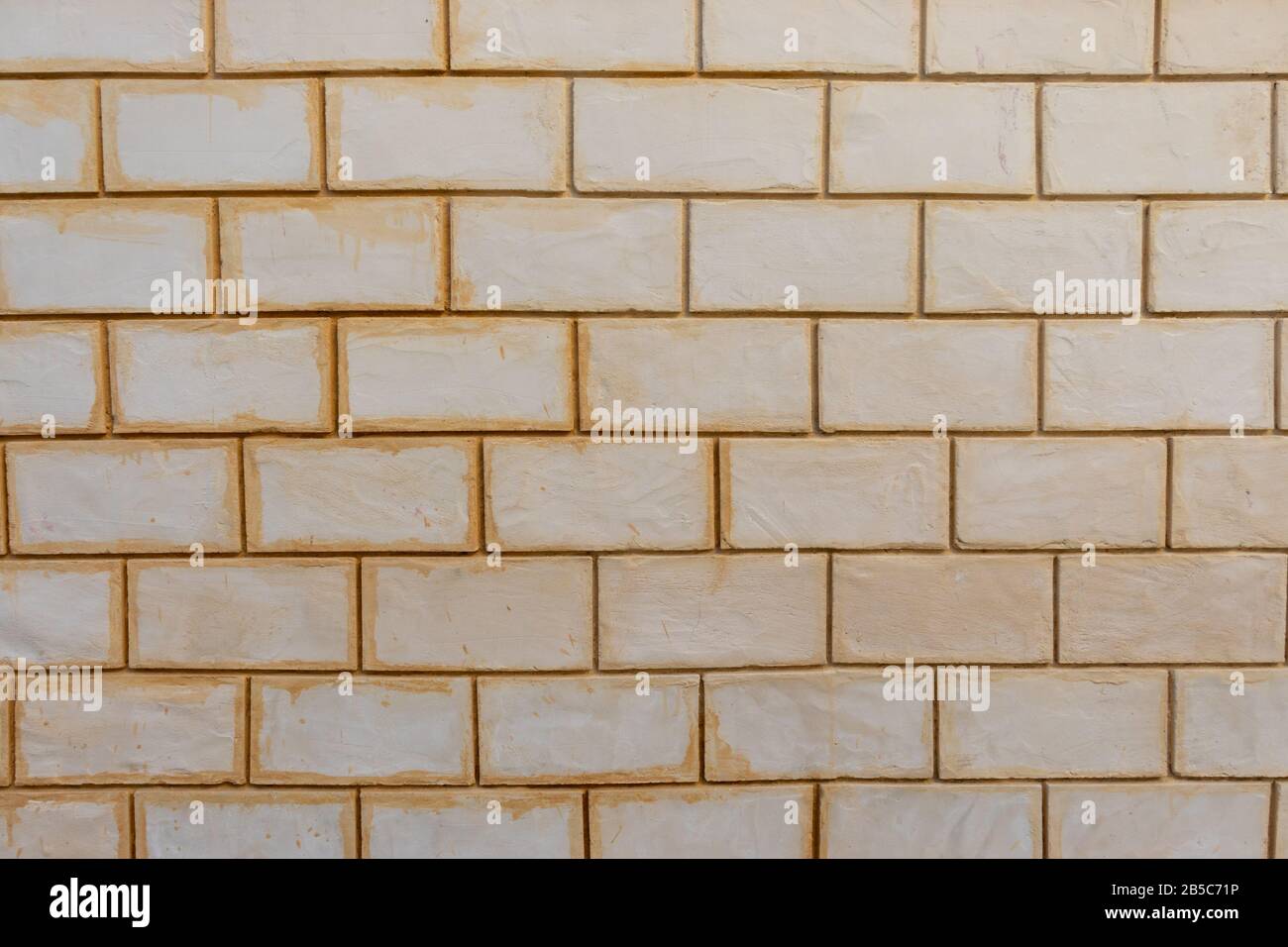 White and yellow dirty bricks background wall Stock Photo