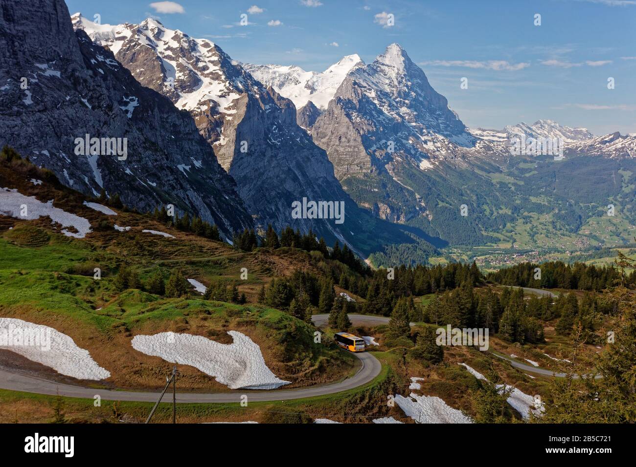 Grosse Scheidegg, Oberhasli, Bern, Switzerland - July 19, 2019: Swiss PostBus heading to Grindelwald with views of Eiger, Moench and Jungfrau massif Stock Photo