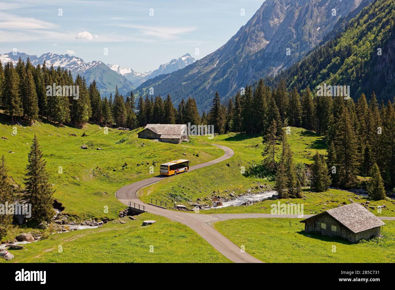 Grosse Scheidegg, Oberhasli, Bern, Switzerland - July 19, 2019: Swiss PostBus heading to Meiringen and passing by alpine meadows of Alpiglen in Upper Stock Photo