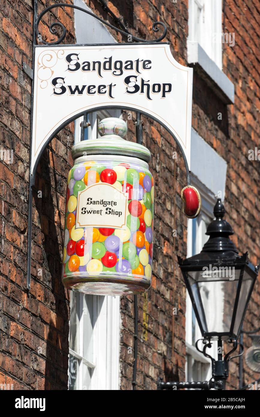 A large colourful confectionery jar sign above an Olde World sweet