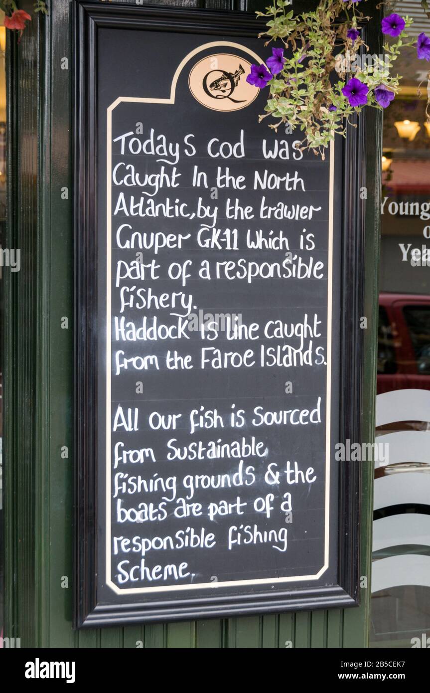 A fresh fish restaurant sign in the historical port of Whitby on the