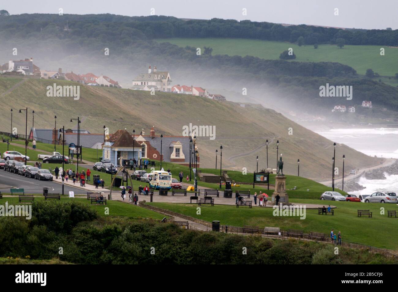 Sea spray  over the cliffs at Whitby, a seaside town and small fishing port on the north Yorkshire coast, facing the North Sea in Britain.  Whitby is Stock Photo