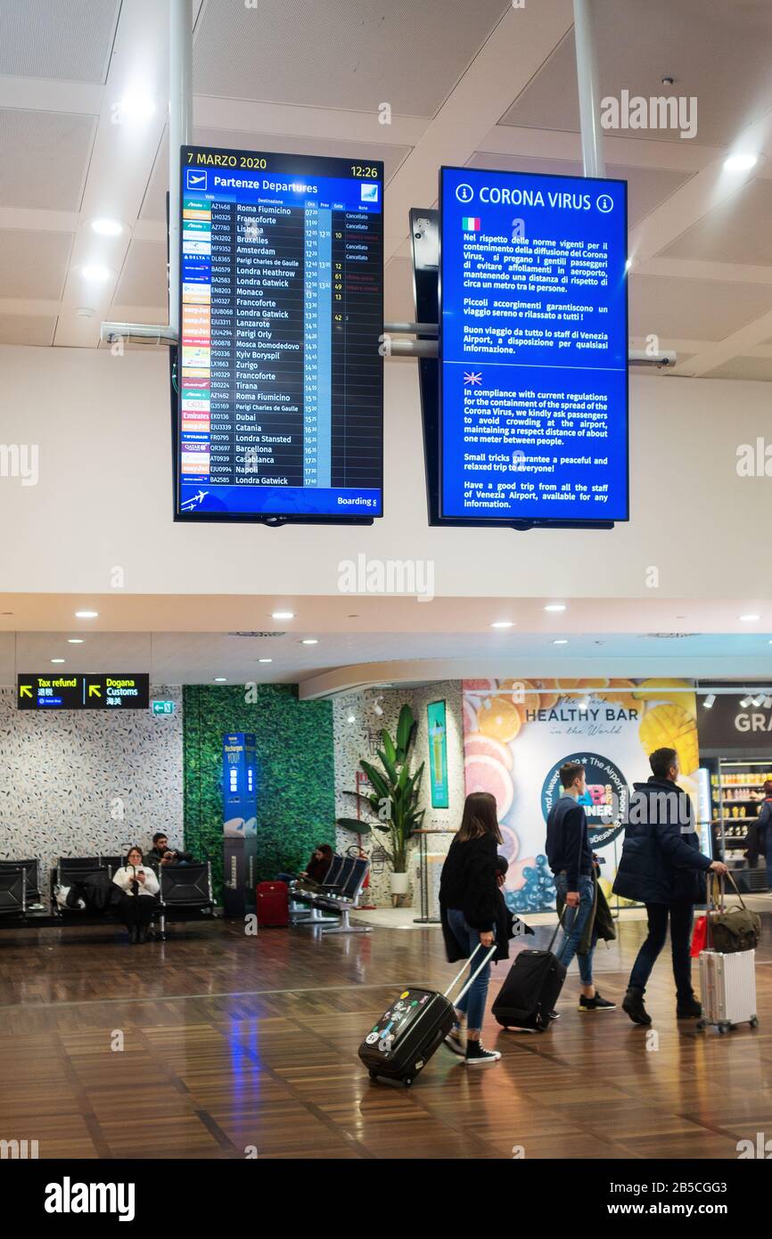 Coronavirus Covid-19 sign and air passengers at Venice Airport, Marco Polo on Saturday 7th March 2020; Wuhan coronavirus; Venice Northern Italy Europe Stock Photo