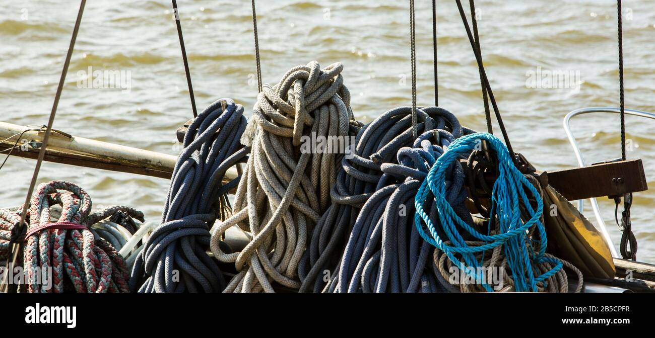 Tidy wound and stowed ropes for the rigging on a wooden ship in Bristol