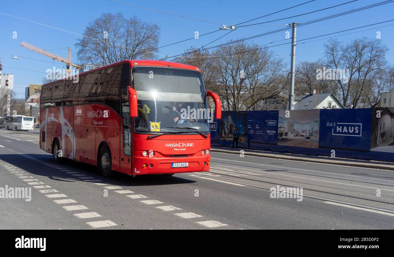 April 20, 2018, Tallinn, Estonia. A red bus with an information sign caution children on a windshield on a street in Tallinn. Stock Photo