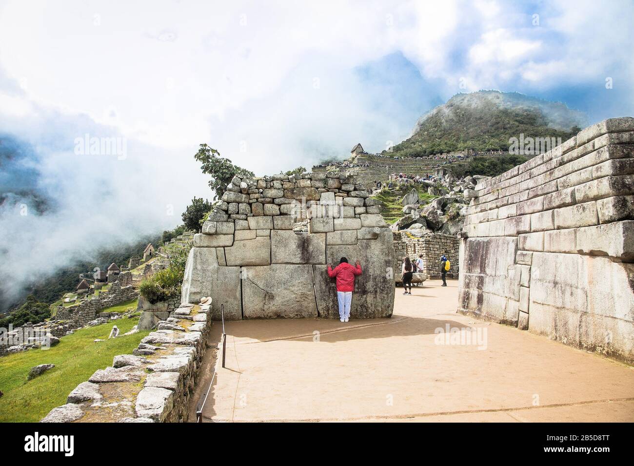 Machu Picchu Pueblo,  Peru - Jan 7, 2019:  Incredible Inca Wall on Ancient city of Machu Picchu in Peru. South America.  Archaeological site. Stock Photo