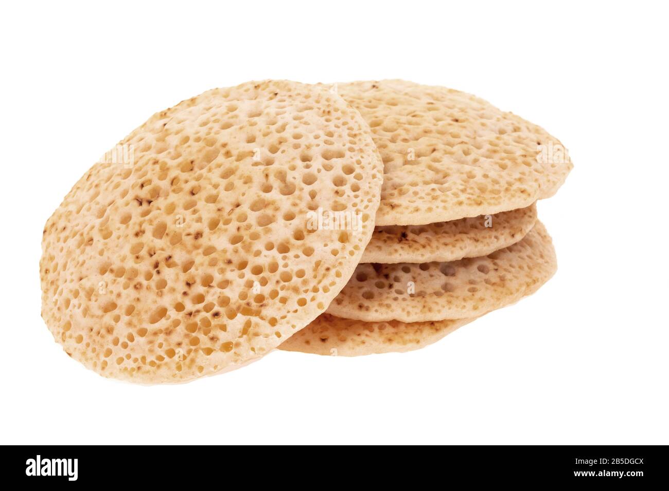 A stack of English crumpets, also known as pikelets - white background ...