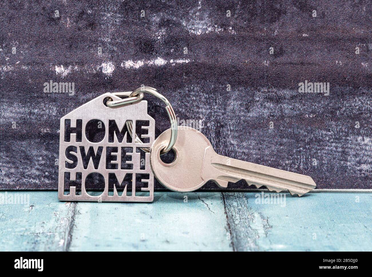 Key on a keyring with a small house, home sweet home Stock Photo