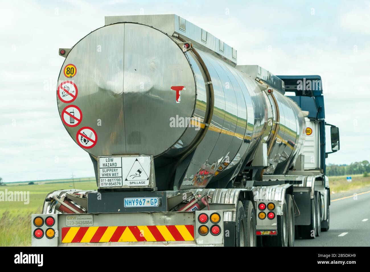 stainless steel tanker truck or vehicle carrying flammable liquid or fuel on a national road in Gauteng, South Africa Stock Photo
