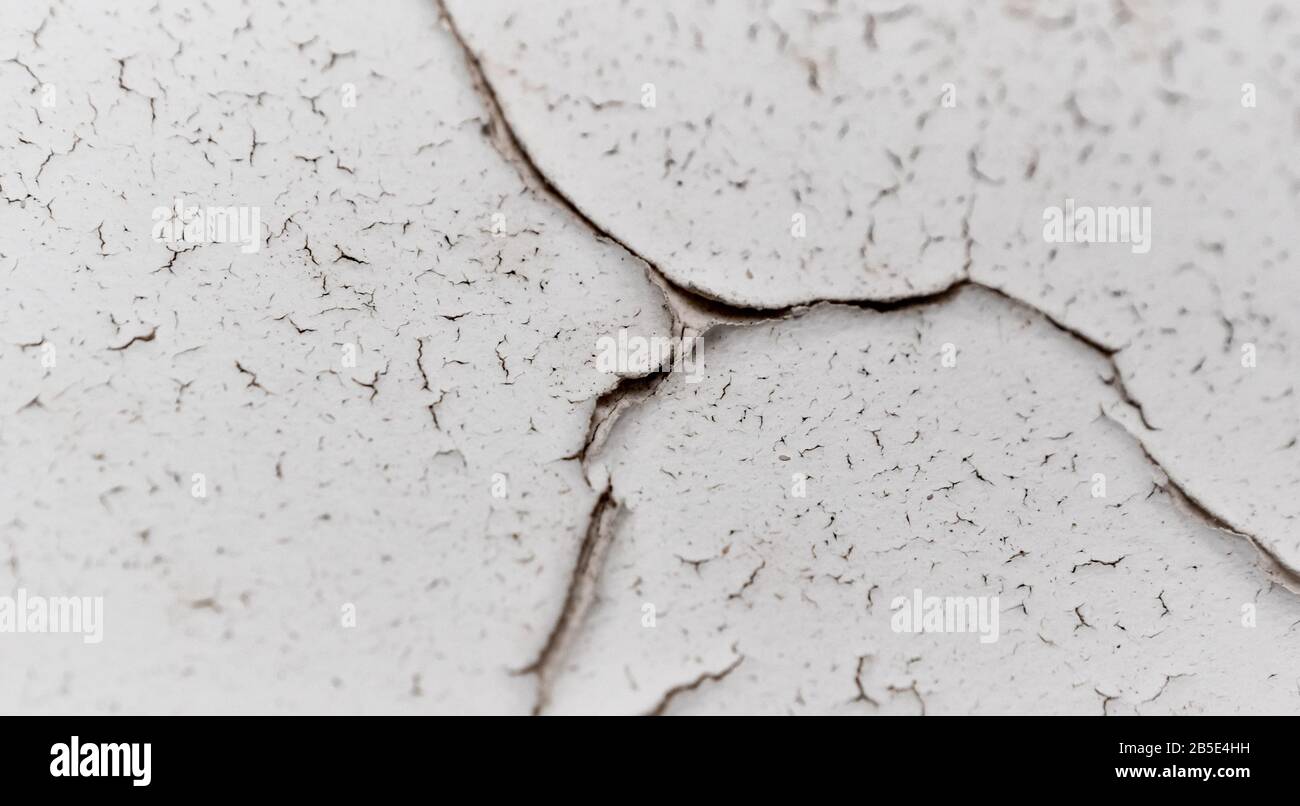 Old white cracked plaster wall surface for background or texture Stock Photo