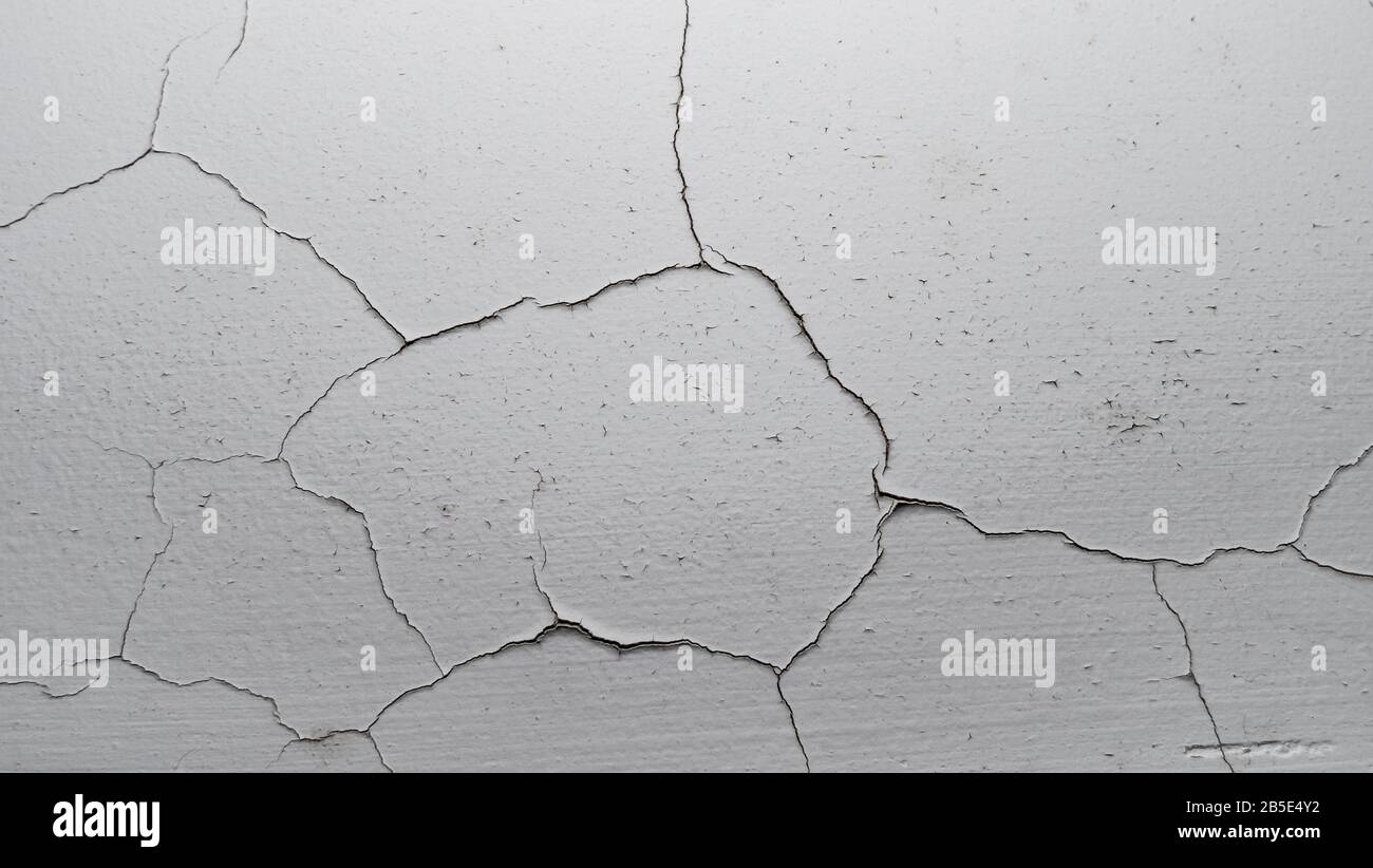 Old white cracked plaster wall surface for background or texture Stock Photo