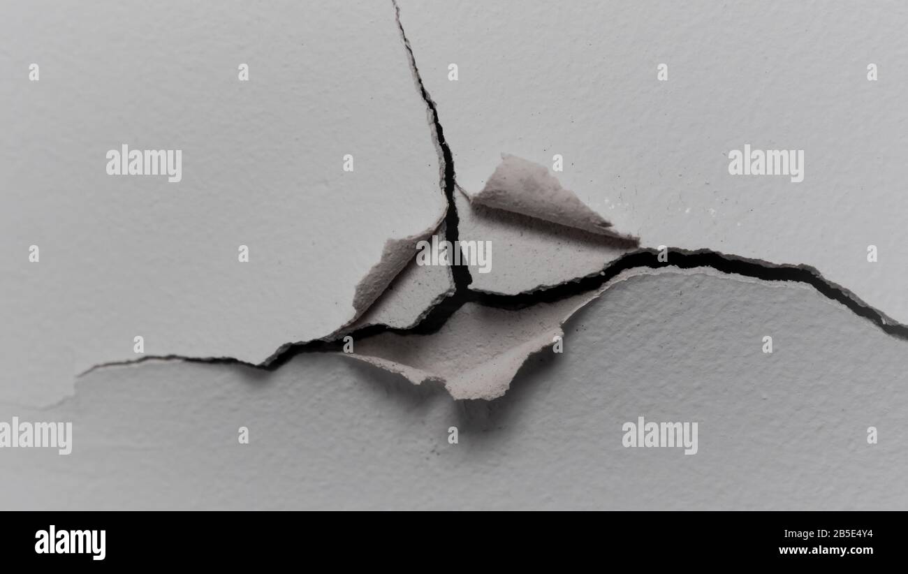 Old white cracked plaster wall surface for background or texture Stock Photo