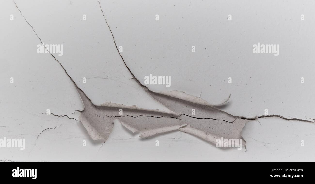 Old white cracked plaster wall surface for background or texture Stock Photo