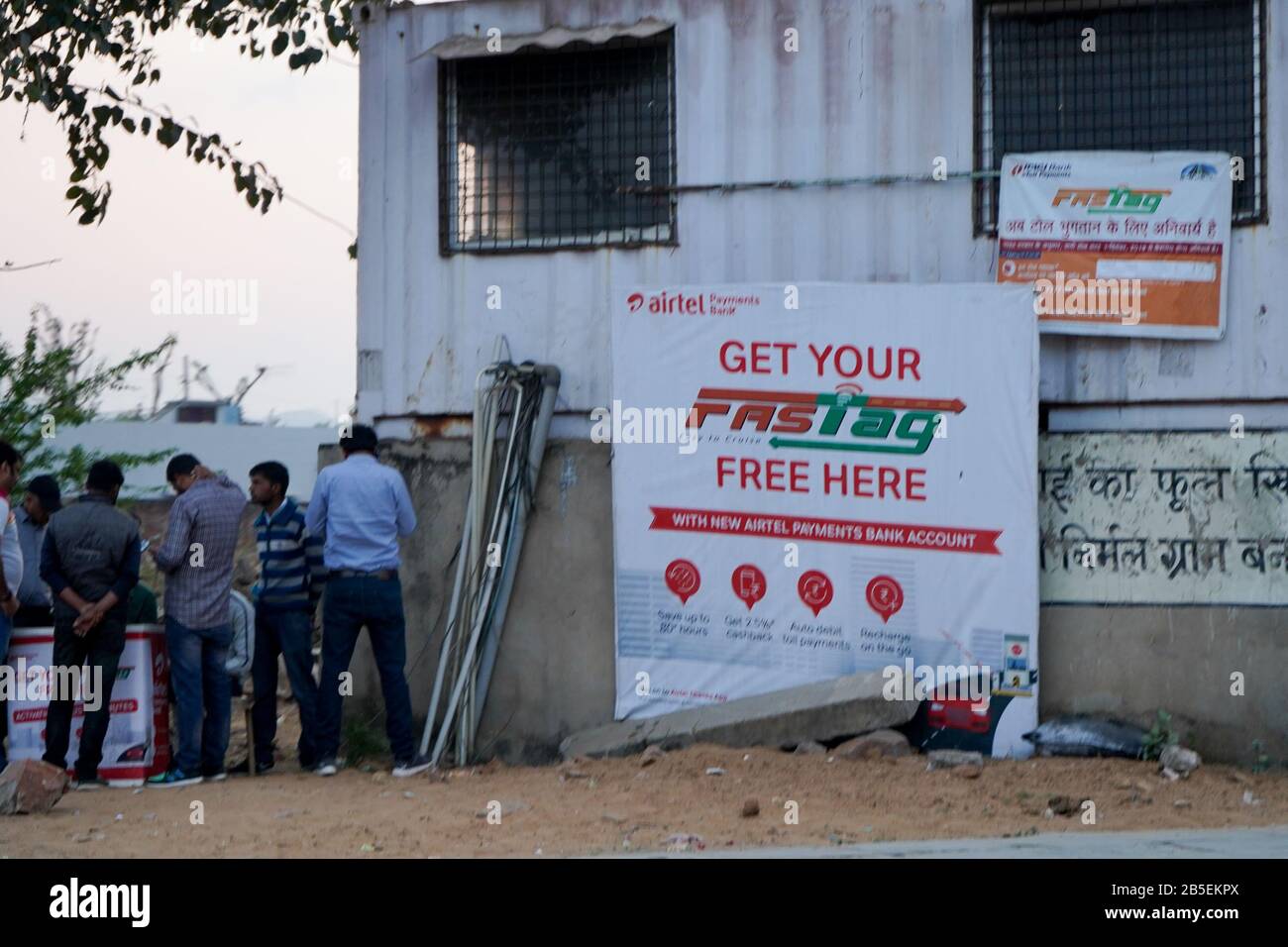 FASTag tag kiosk at toll booth with people lining up to collect the