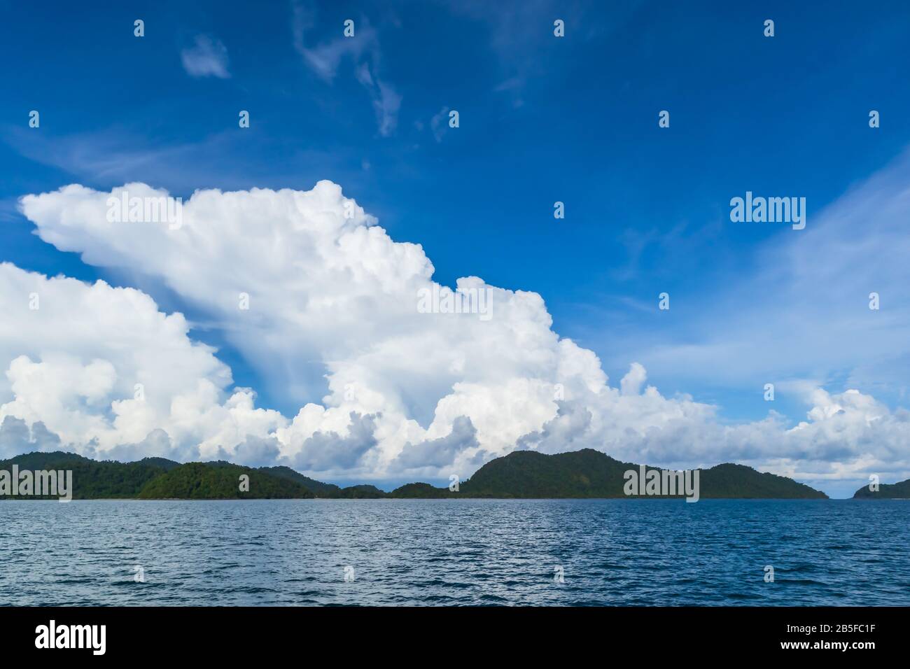 Blue sky with white cloud and deep blue sea Stock Photo - Alamy