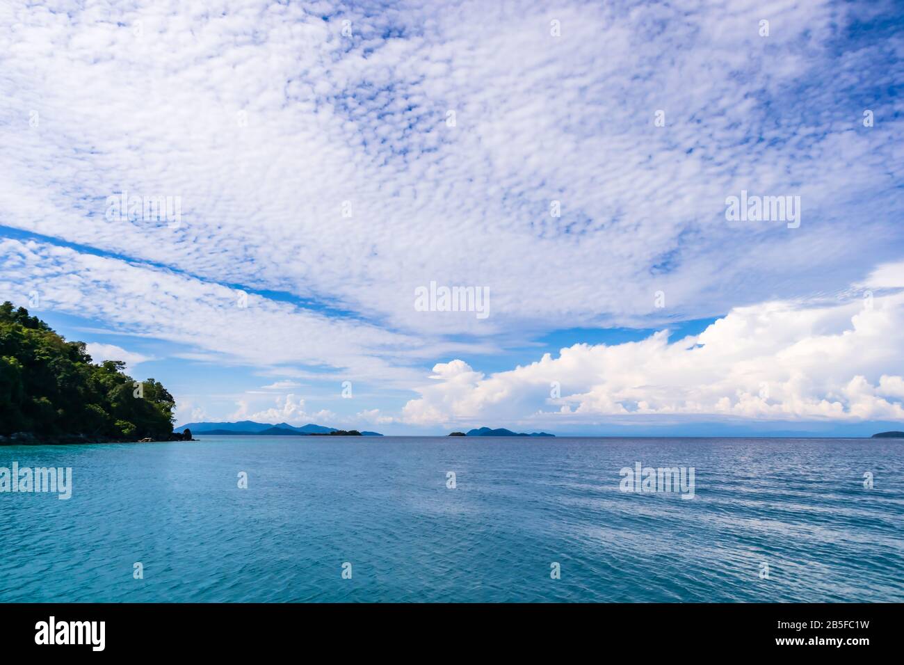 Blue sky with white cloud and deep blue sea Stock Photo - Alamy