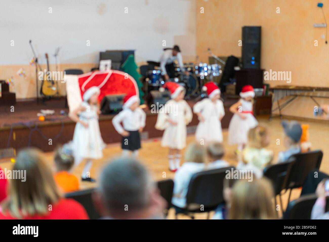 Many parents are watching the kids performance in the hall. Children on ...